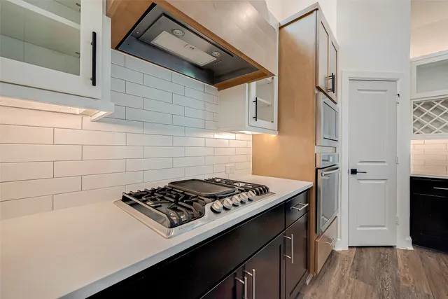 a kitchen with a stove and a refrigerator