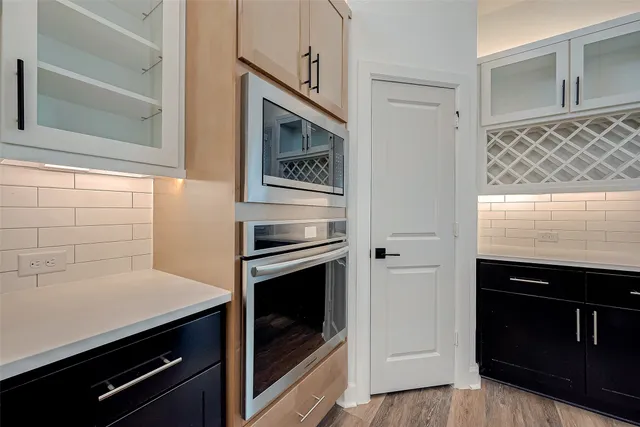 a kitchen with cabinets and stainless steel appliances