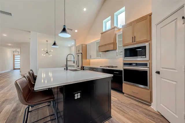 a kitchen with a sink cabinets and wooden floor