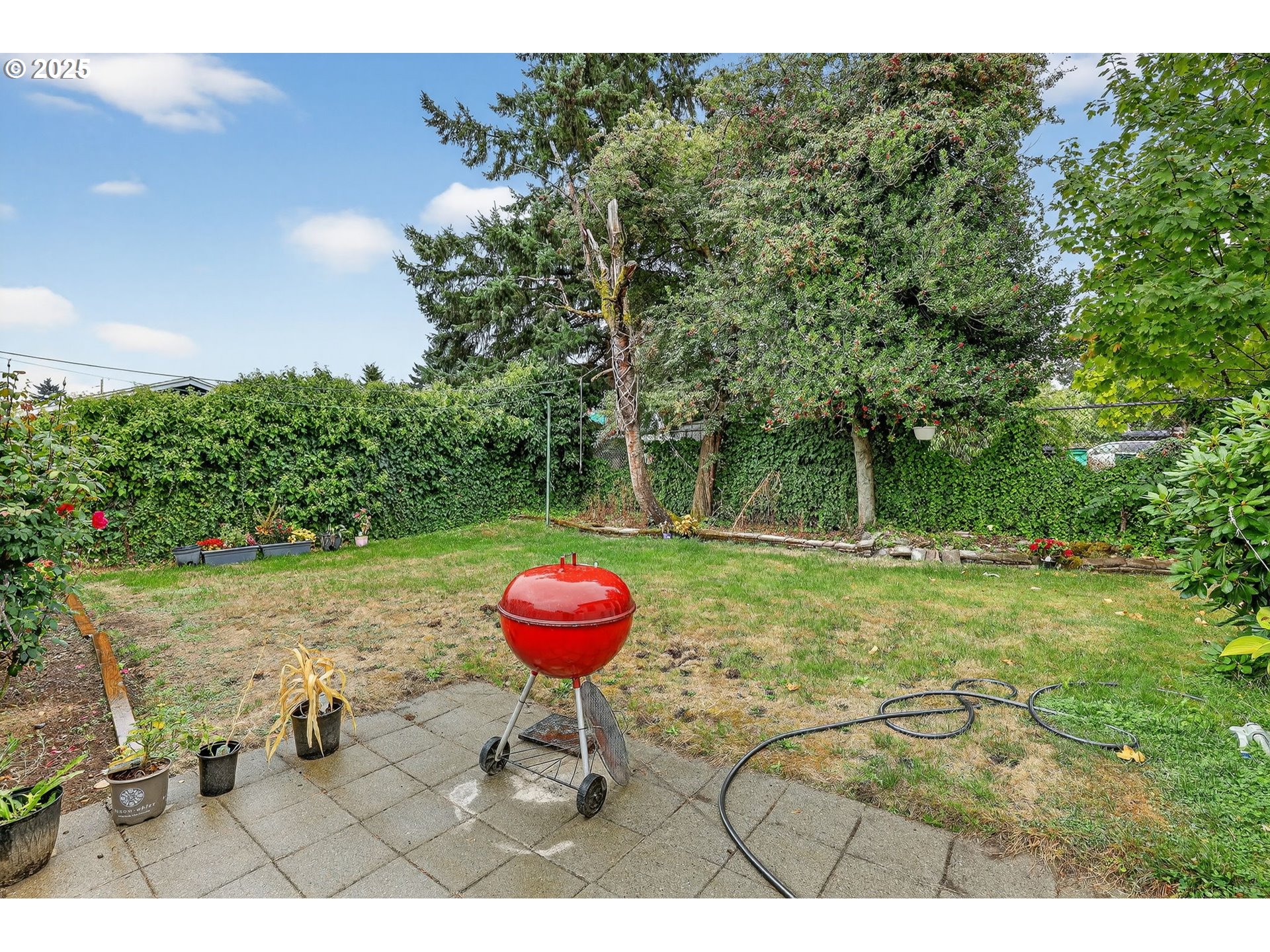 6404 Northeast 10th Avenue Portland, OR 97211 - Photo 23 of 31 a view of a backyard with table and chairs and potted plants