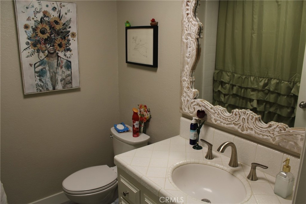 8267 San Bernardino Road Rancho Cucamonga, CA 91730 - Photo 15 of 32 a bathroom with a sink a toilet and a mirror