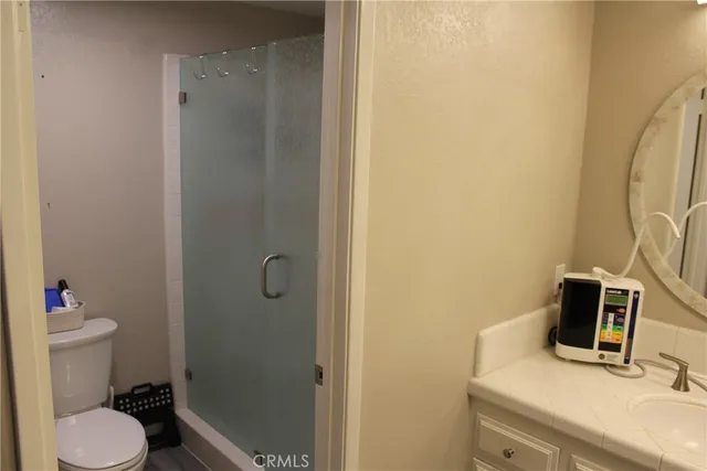 a bathroom with a granite countertop sink toilet and shower
