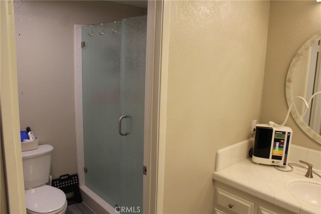 8267 San Bernardino Road Rancho Cucamonga, CA 91730 - Photo 17 of 32 a bathroom with a granite countertop sink toilet and shower