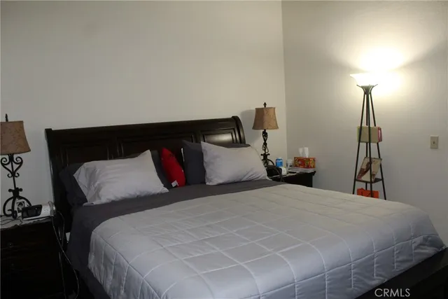 a bedroom with a bed and a night stand