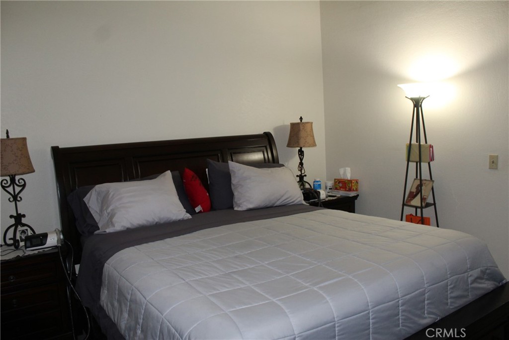 8267 San Bernardino Road Rancho Cucamonga, CA 91730 - Photo 19 of 32 a bedroom with a bed and a night stand
