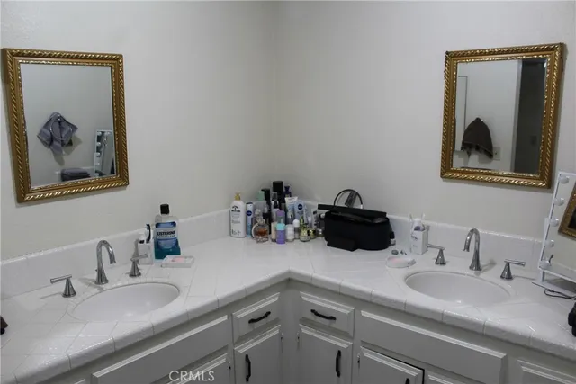 a bathroom with a double vanity sink and a mirror