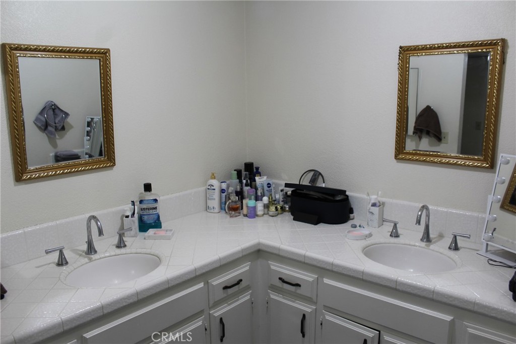 8267 San Bernardino Road Rancho Cucamonga, CA 91730 - Photo 20 of 32 a bathroom with a double vanity sink and a mirror
