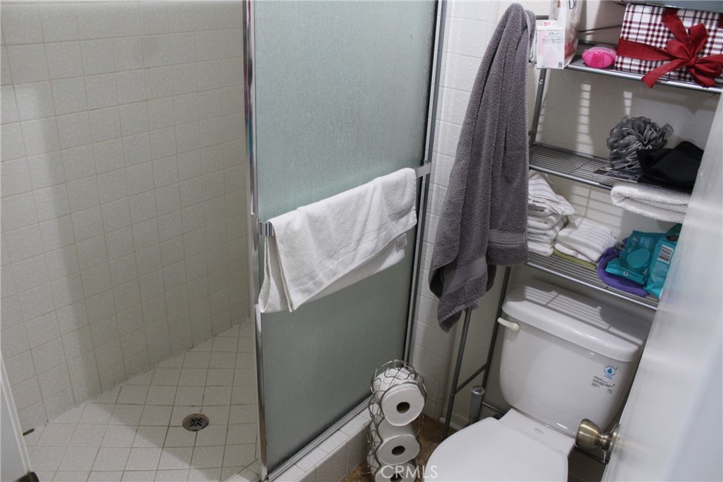 8267 San Bernardino Road Rancho Cucamonga, CA 91730 - Photo 21 of 32 a bathroom with a toilet and a shower