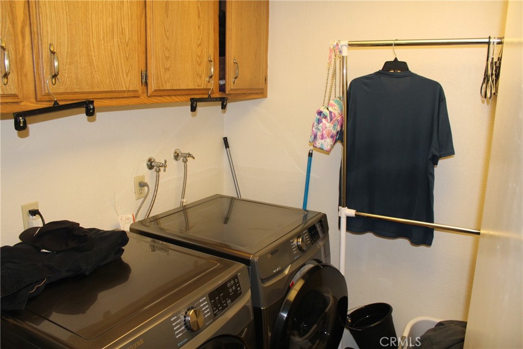 8267 San Bernardino Road Rancho Cucamonga, CA 91730 - Photo 23 of 32 a blue kitchen with a stove and a wooden floor