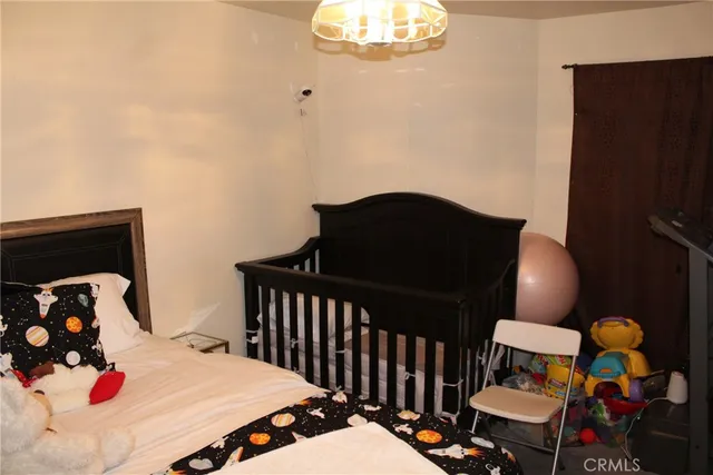 a bedroom with a bed and dresser