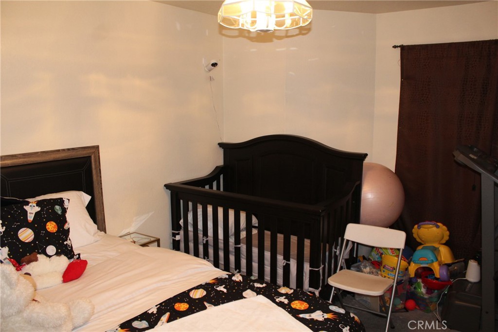 8267 San Bernardino Road Rancho Cucamonga, CA 91730 - Photo 24 of 32 a bedroom with a bed and dresser