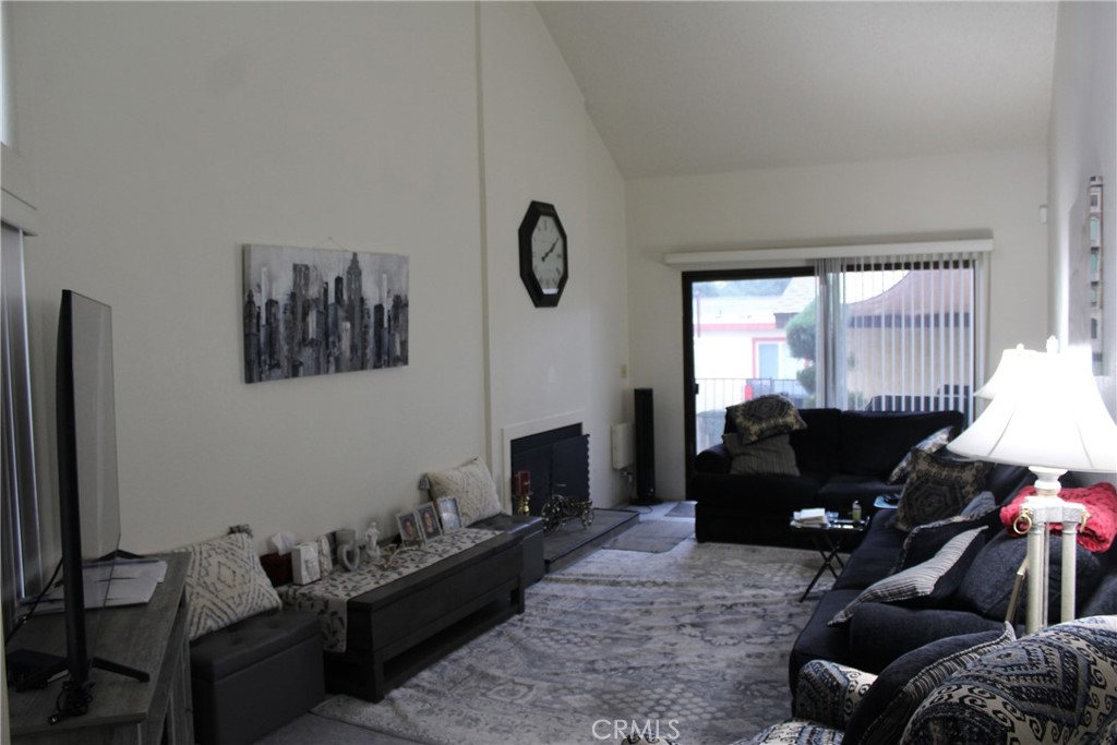 8267 San Bernardino Road Rancho Cucamonga, CA 91730 - Photo 26 of 32 a living room with furniture windows and a fireplace