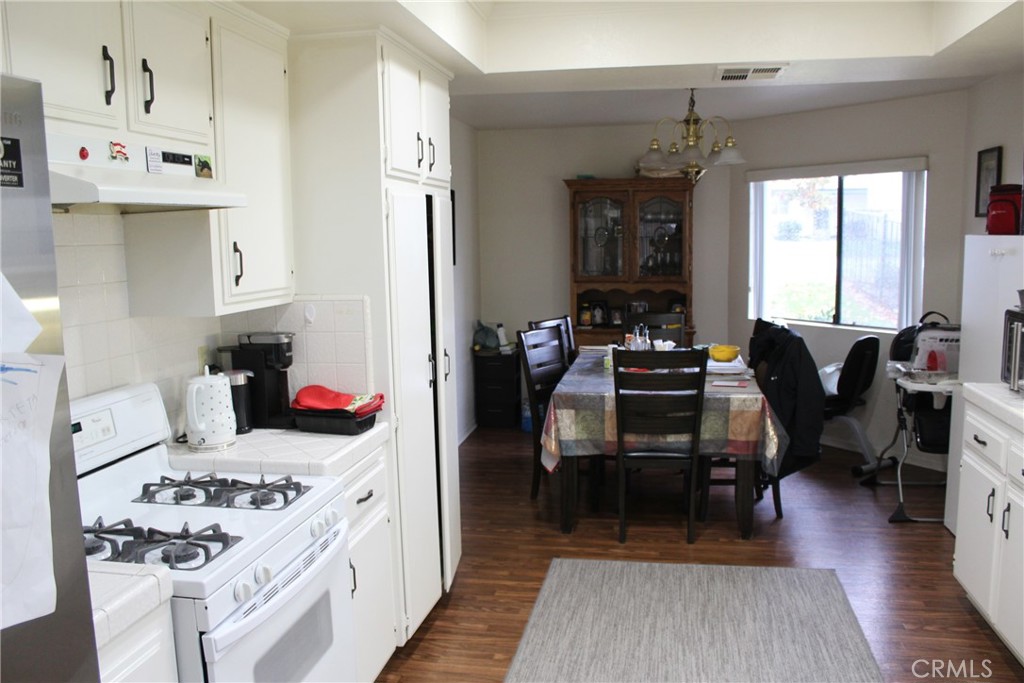 8267 San Bernardino Road Rancho Cucamonga, CA 91730 - Photo 28 of 32 a kitchen with a stove and wooden floor