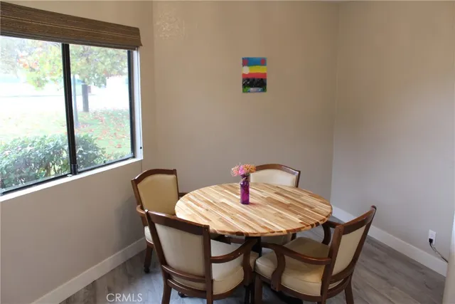 a view of a dining room with a table and chairs