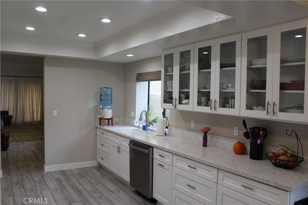 8267 San Bernardino Road Rancho Cucamonga, CA 91730 - Photo 6 of 32 a kitchen with a sink and wooden floor