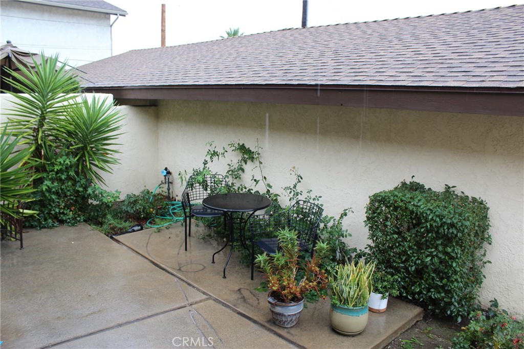8267 San Bernardino Road Rancho Cucamonga, CA 91730 - Photo 9 of 32 a backyard of a house with plants and outdoor seating