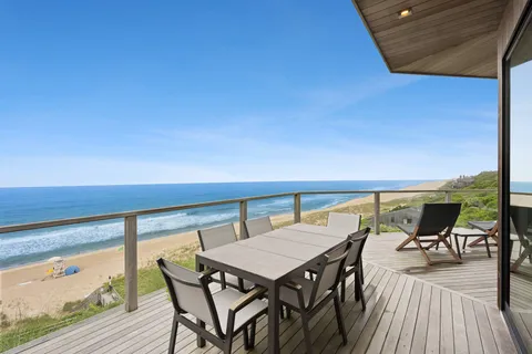 a roof deck with a table and chairs