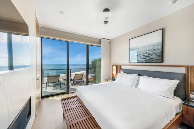 a bedroom with a large bed and a tv