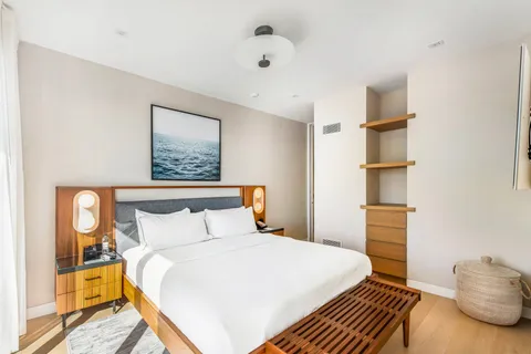 a bedroom with a bed and a cabinets