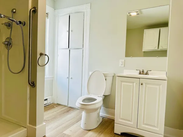 a bathroom with a granite countertop toilet sink and shower