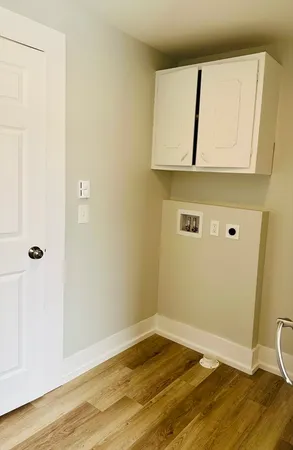 a view of a room with wooden floor and cabinet