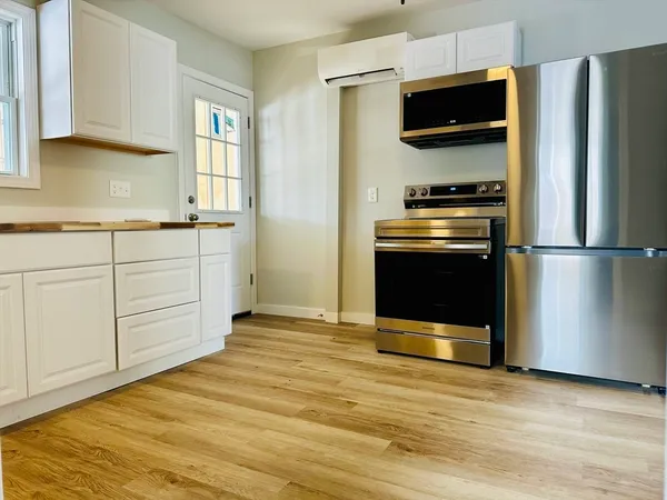 a kitchen with stainless steel appliances granite countertop a refrigerator and a stove top oven