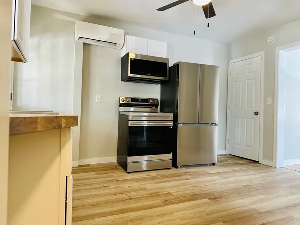 a kitchen with stainless steel appliances a refrigerator stove and microwave