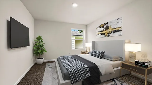 a bedroom with a bed and a flat screen tv