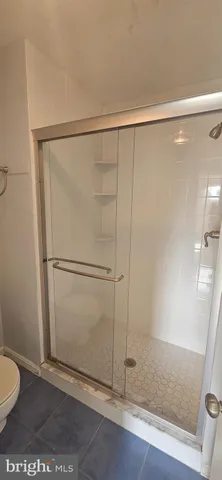 a bathroom with a glass shower door