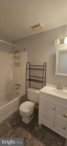 a bathroom with a toilet a sink and bathtub