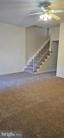 a view of an empty room with stairs