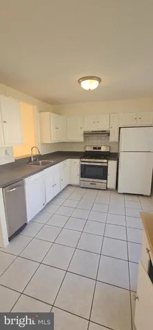 a kitchen with stainless steel appliances cabinets a sink and a stove