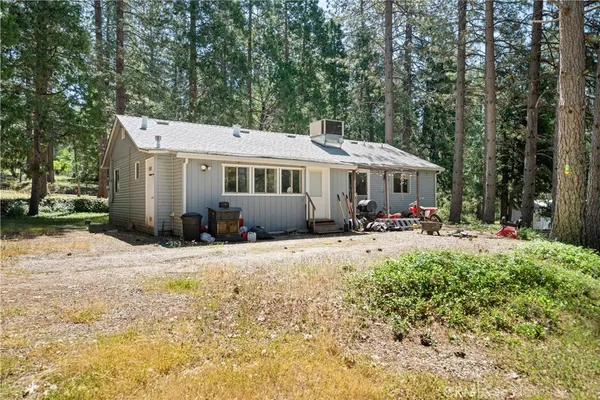 a view of a house with backyard and sitting area