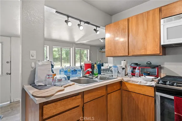 a kitchen with a sink cabinets and appliances