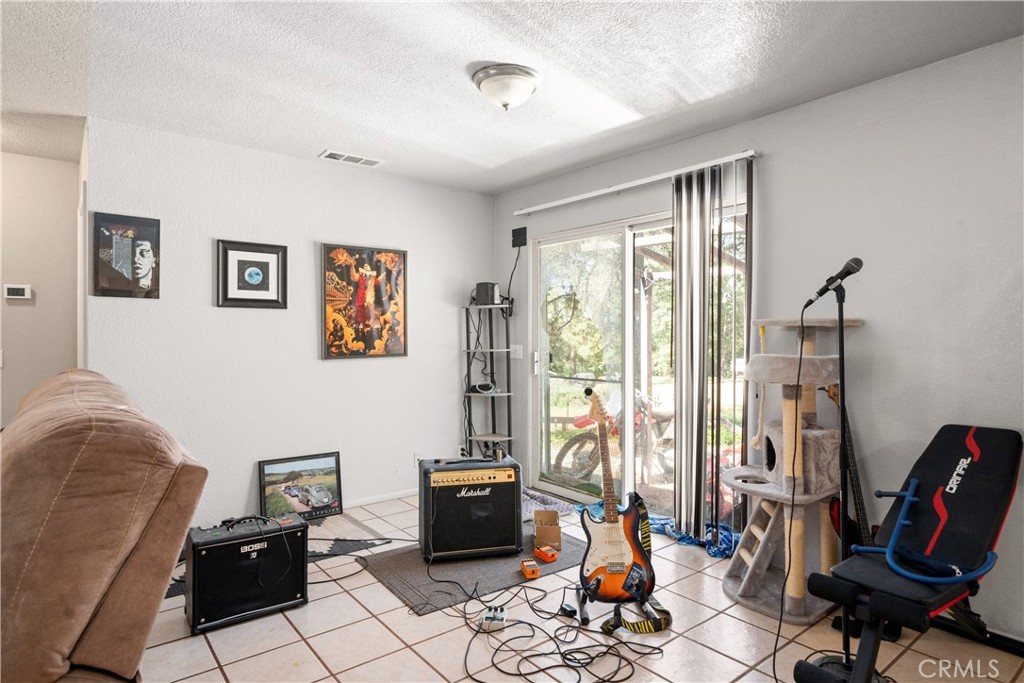 9803 Cohasset Road Chico, CA 95973 - Photo 9 of 22 a living room with furniture a rug and a large window