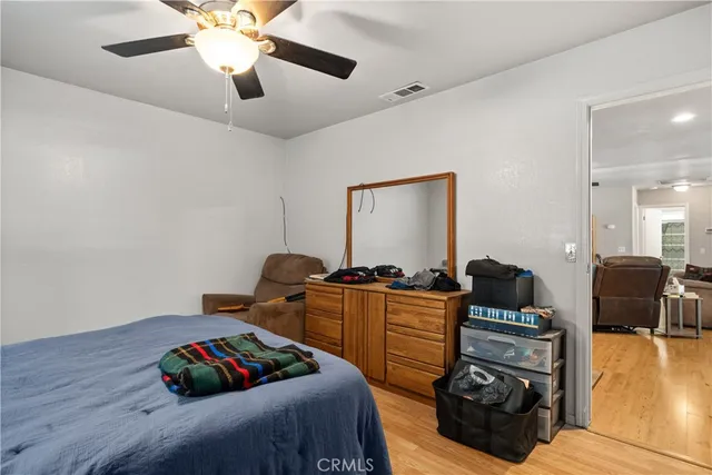 a bedroom with furniture and a wooden floor