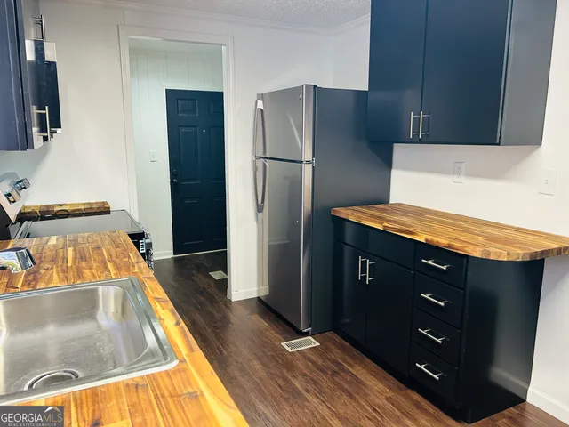 a kitchen with stainless steel appliances granite countertop a sink stove and microwave