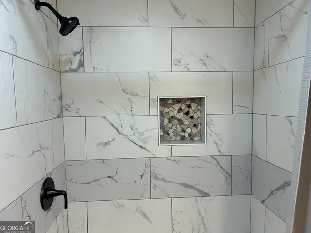 an empty room with wooden floor and a window