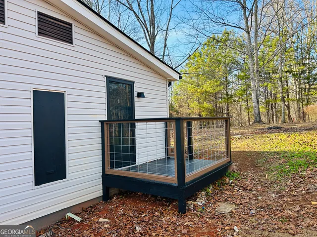 an empty room with wooden floor and fireplace