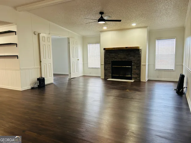 a large kitchen with a wooden floor and a large window