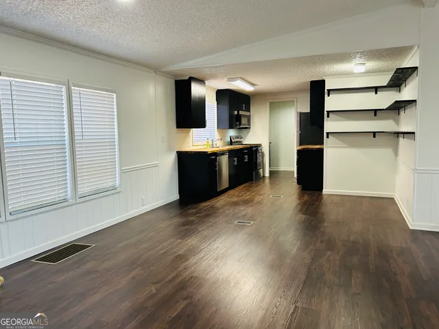 a view of kitchen with furniture and wooden floor