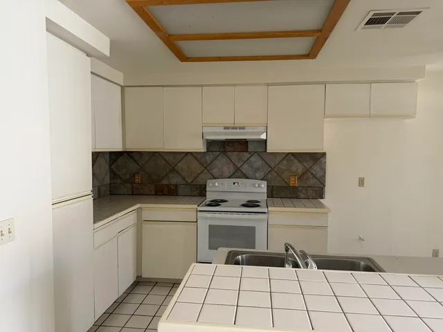 a kitchen with cabinets and appliances