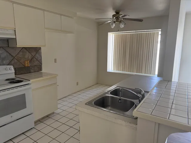 a kitchen that has a sink and a stove
