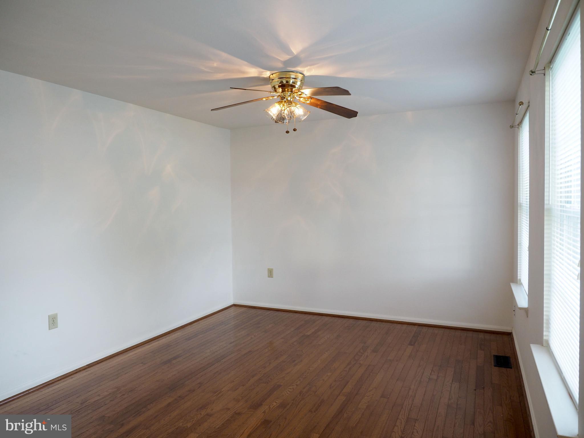 118 Ranson Estates Circle Ranson, WV 25438 - Photo 3 of 15 an empty room with wooden floor fan and windows