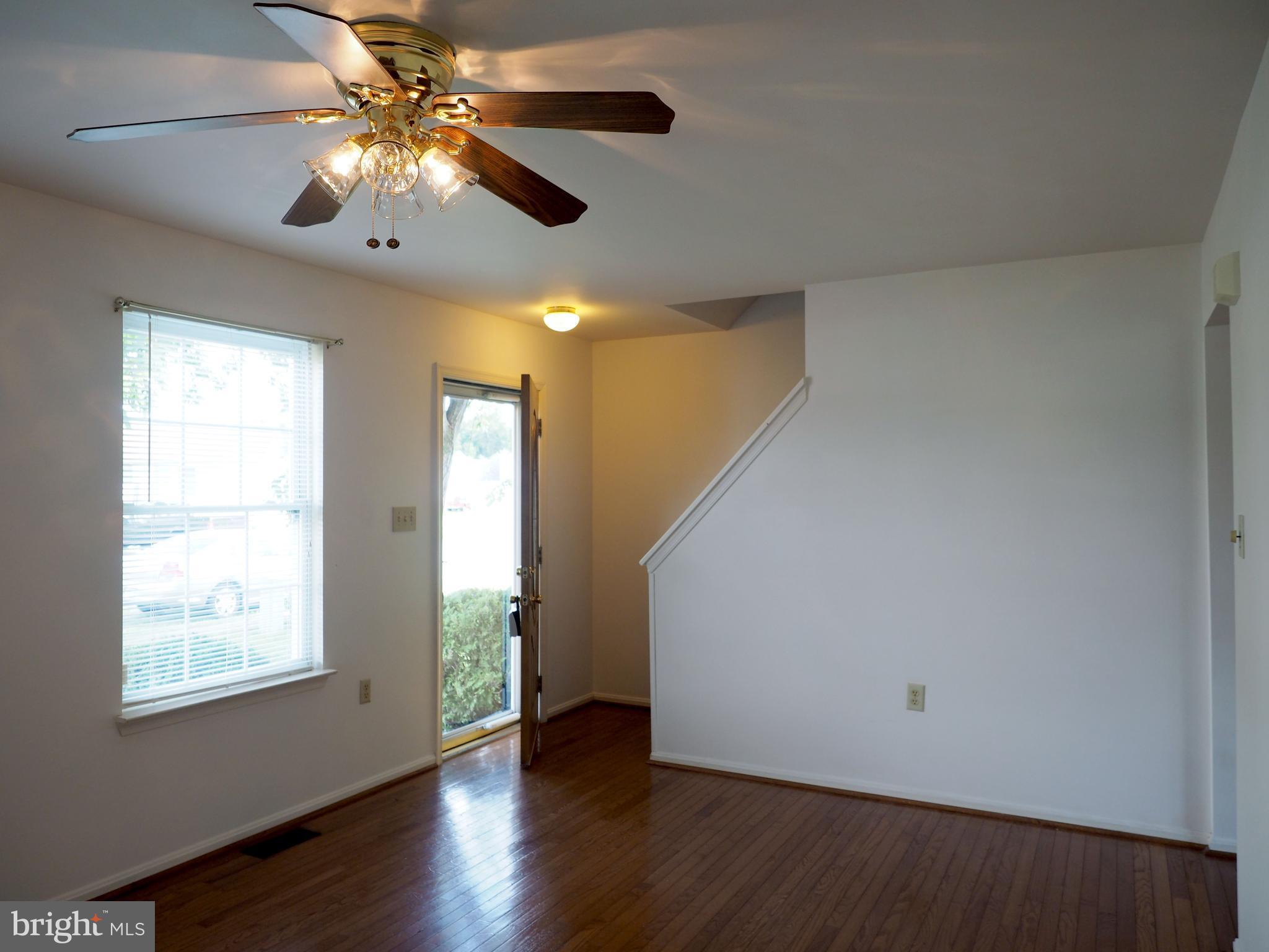 118 Ranson Estates Circle Ranson, WV 25438 - Photo 4 of 15 an empty room with wooden floor fan and windows
