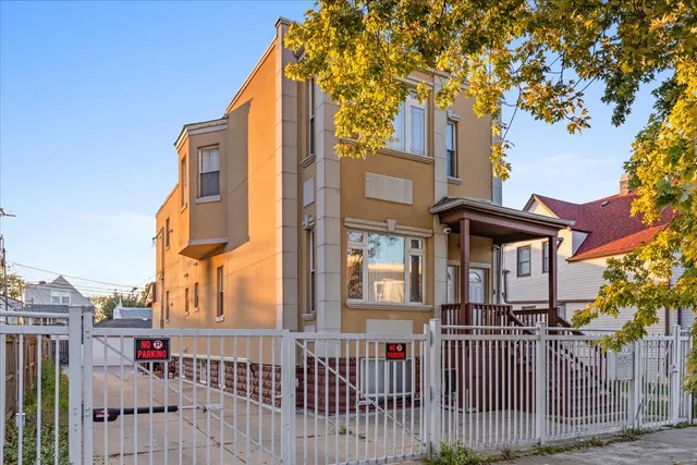 a front view of a house with a iron gate