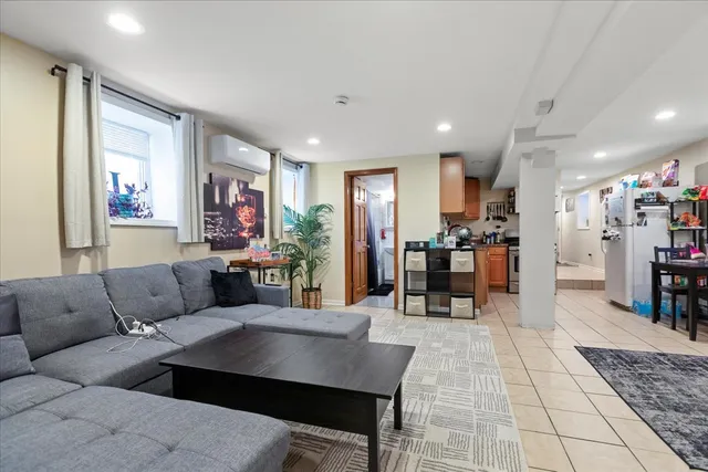 a living room with furniture and kitchen view