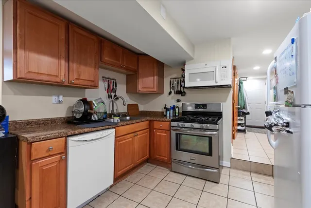 a kitchen with stainless steel appliances granite countertop a sink stove and cabinets