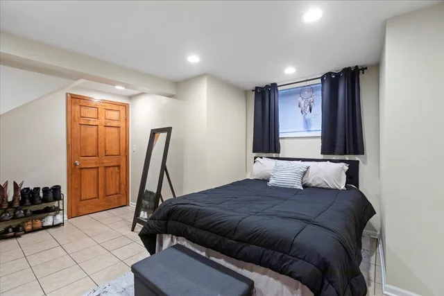 a bedroom with a bed a couch and dresser