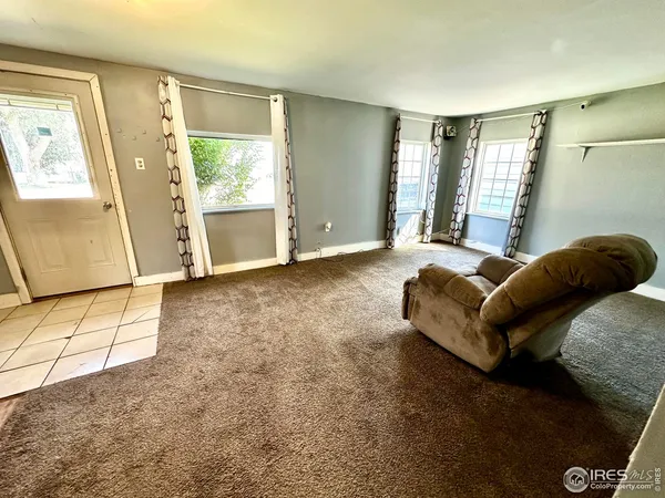 a spacious bedroom with a bed and wooden floor